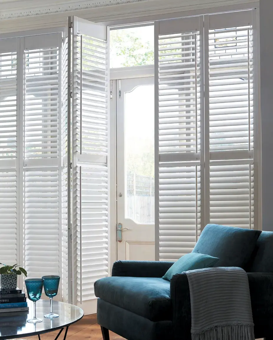 Tracked plantation shutters in a bright living room