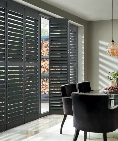 Black tracked plantation shutters fitted in a modern Cardiff apartment or lounge