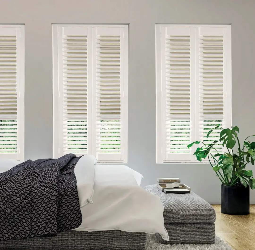 Bedroom with made-to-measure plantation shutters and coordinating shade